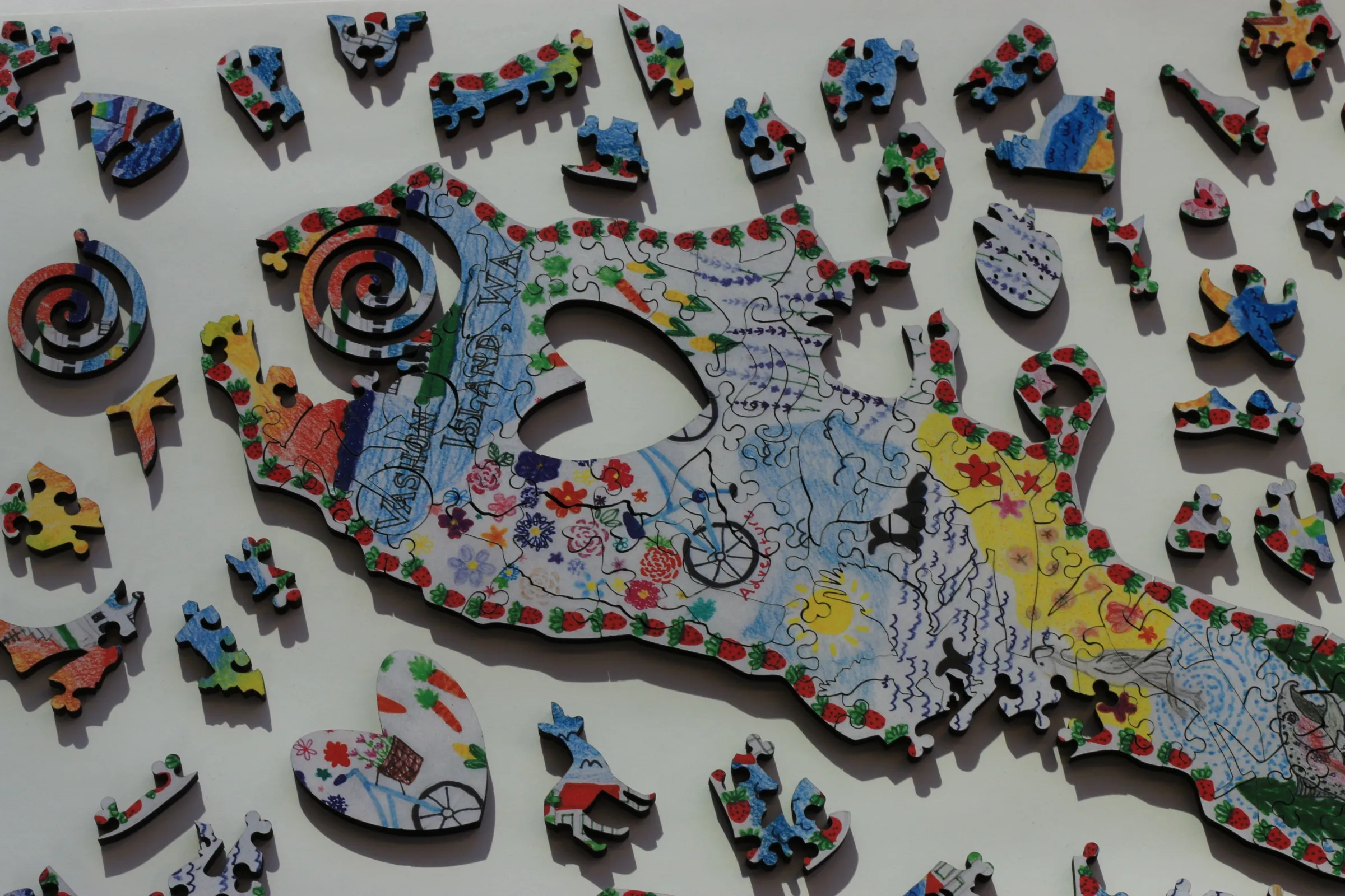 The Vashon Island puzzle surrounded by its whimsical pieces